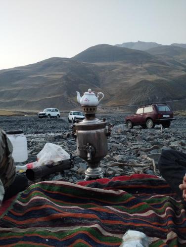 a tea pot sitting on top of a pile of rocks at Zaur Guest hause in Xınalıq