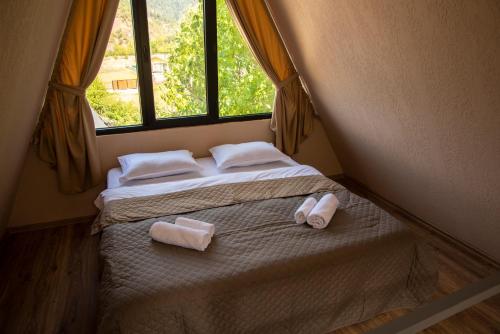 a bedroom with two beds with towels on them at Landhaus Borjomi in Borjomi