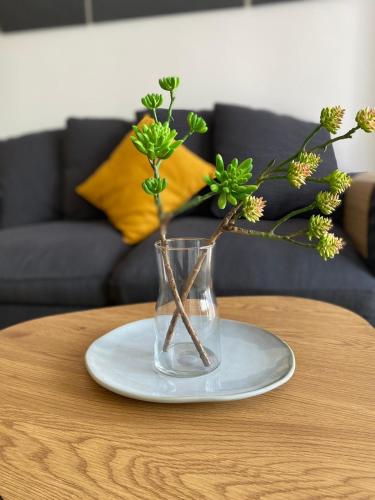 a vase with flowers in it on a table at HO!HOUSE SHELLTER ROGOWO in Rogowo