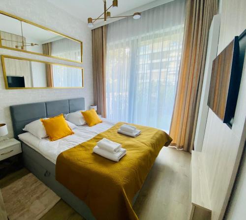 a bedroom with a bed with two towels on it at HO!HOUSE SHELLTER ROGOWO in Rogowo