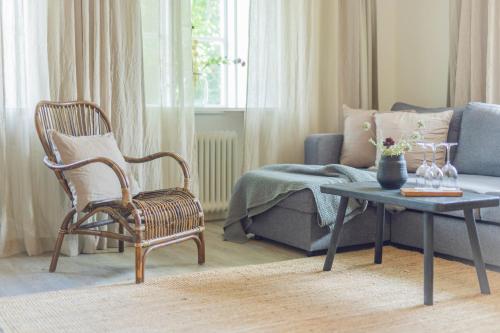 a living room with a couch and a chair and a table at Gumbalde Resort in Stånga