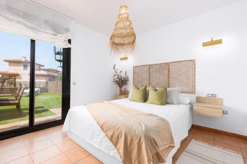 Ένα ή περισσότερα κρεβάτια σε δωμάτιο στο Home2Book Casa Calma