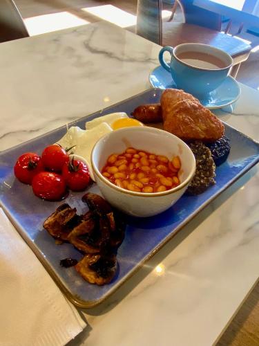 a tray of food with a bowl of food and a cup of coffee at Balcomie Links Hotel in Anstruther