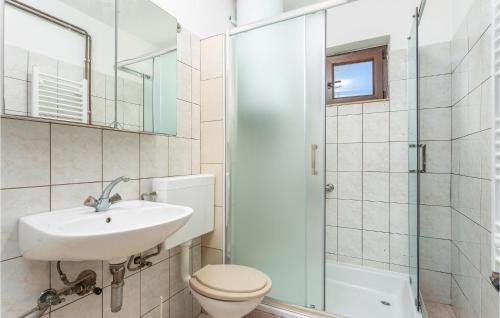 a bathroom with a sink and a toilet and a shower at 2 Bedroom Lovely Apartment In Njivice in Njivice