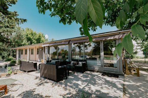 a pavilion with a table and chairs on a patio at Zam-zam apartmanok in Zamárdi