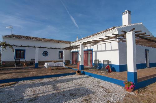 a patio of a white house with a roof at Monte Farropo in Monsaraz