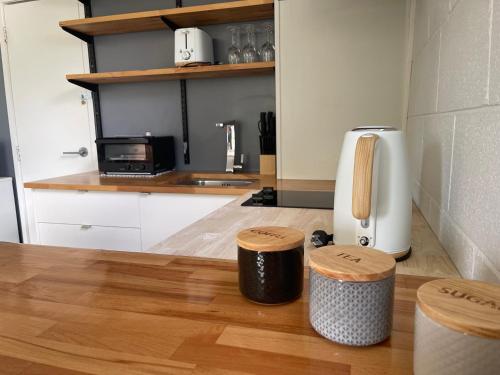 a kitchen with a counter and two stools at Private 2 bedrooms suite with free parking in Rotorua