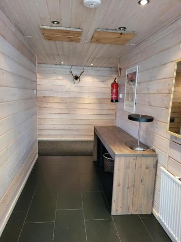 a sauna with a bench in a room with wooden walls at Chalet Päämaja Rovaniemi in Rovaniemi