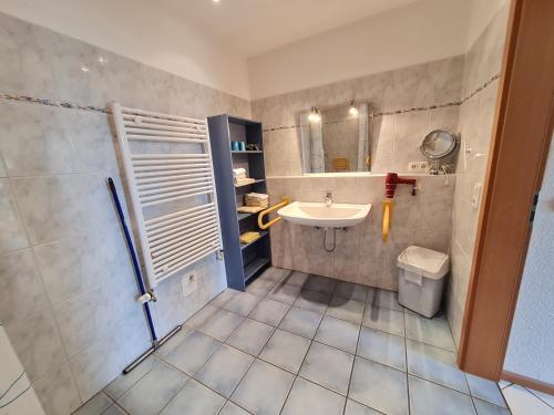 a bathroom with a sink and a shower and a toilet at Haus Ekke Nekkepenn II, Haus Ekke Nekkepenn II, Whg D1 in Wyk auf Föhr