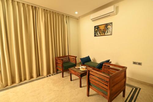 a room with two chairs and a couch and a table at Clarks Safari Ranthambore in Khilchipur