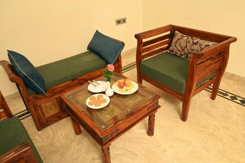 a living room with two chairs and a coffee table at Clarks Safari Ranthambore in Khilchipur