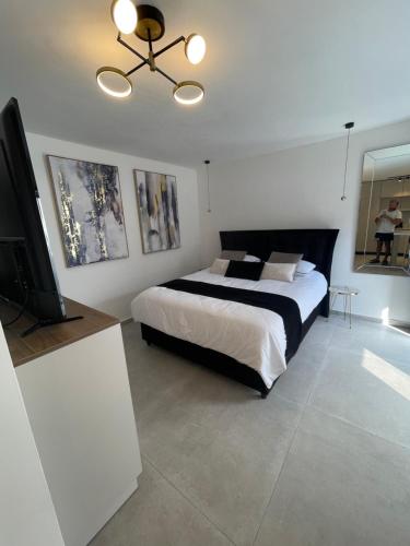 a bedroom with a bed and a flat screen tv at rooms 48 in Eilat