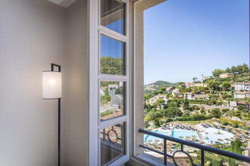 a window with a view of a resort at Le Fregate Provence in Bandol