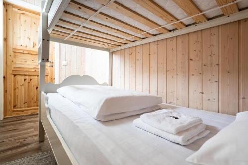 two beds in a room with white towels on them at Eliassen Rorbuer in Reine