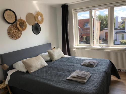 a bedroom with a bed with two towels on it at Short Stay Zandvoort in Zandvoort