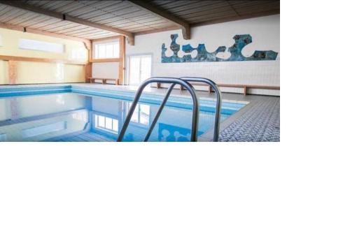 a swimming pool in a house with a pool at Ferienwohnung Oberstdorf in Oberstdorf