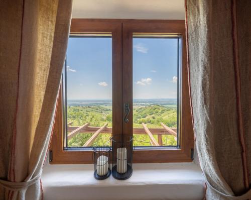 a window with two vases in front of it at Kmečka Hiška - Hiša vina Cuk in Lendava