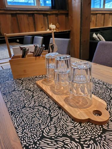 a wooden table with glasses on top of a table at Chalet Päämaja Rovaniemi in Rovaniemi