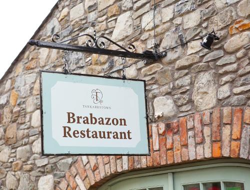 a sign for a restaurant on the side of a building at Tankardstown House in Slane