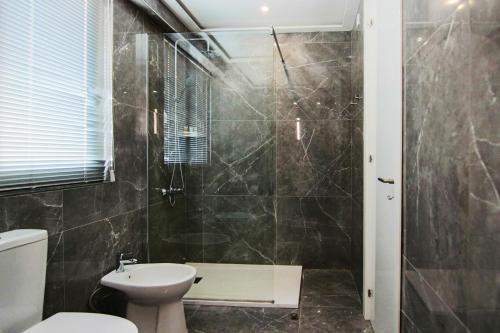 a bathroom with a shower and a toilet and a sink at Phaedrus Living: Luxury Suite Nicosia 503 in Nicosia