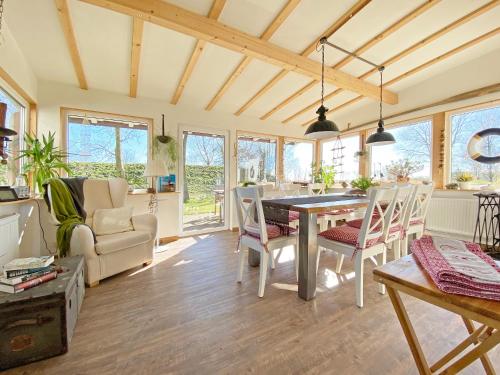 a living room with a table and chairs at Pension Altes Zollhaus in Norden