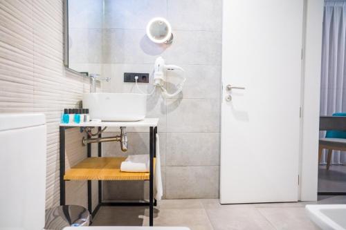 a bathroom with a sink and a mirror at Moon Hotel & SPA. in Aguadulce