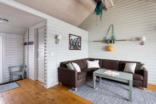 a living room with a couch and a table at Eliassen Rorbuer in Reine