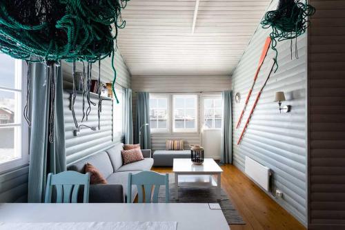 a living room with a couch and a table at Eliassen Rorbuer in Reine