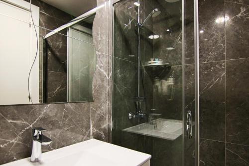 a bathroom with a shower with a toilet and a sink at Phaedrus Living: Luxury Suite Nicosia 504 in Nicosia