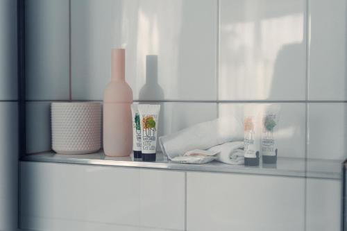 a shelf with bottles and other items on it at Hotel Rössli Luterbach in Luterbach