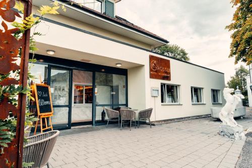 a building with a table and chairs outside of it at Hotel Rössli Luterbach in Luterbach
