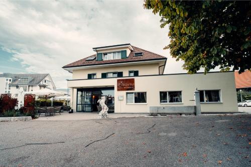 a person walking in front of a building at Hotel Rössli Luterbach in Luterbach