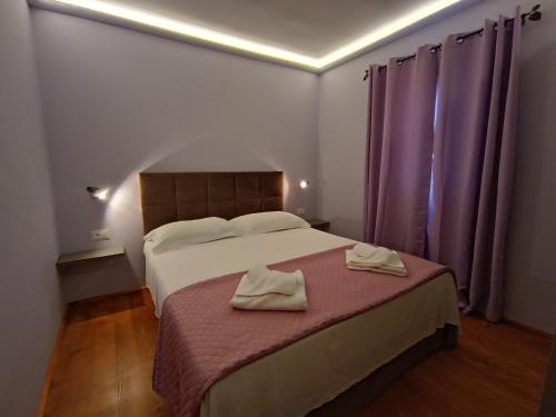 a bedroom with a bed with two towels on it at Moratto's Apartments in Umag