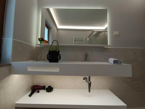 a bathroom with a sink and a mirror at Moratto's Apartments in Umag