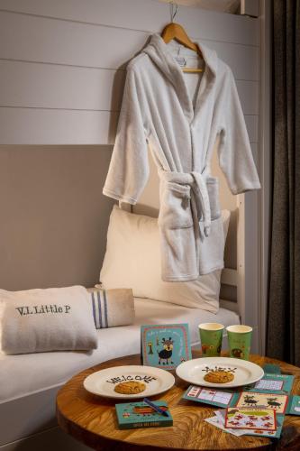 a room with a table with two plates on a bed at Cottons Hotel and Spa in Knutsford
