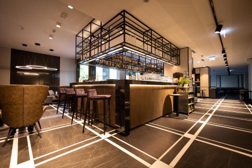 a bar in a restaurant with stools at GINN City & Lounge Yorck Berlin in Berlin