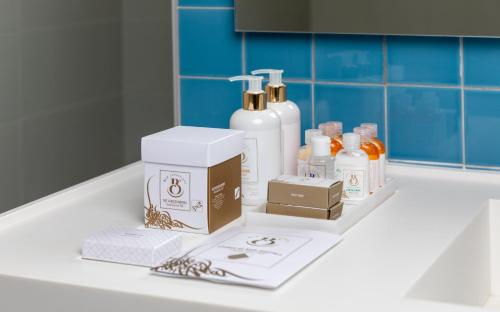 a counter with bottles of soap and a box on it at Royal Azur Thalassa in Hammamet