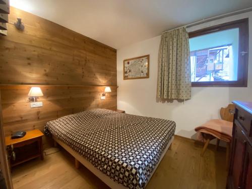 a small bedroom with a bed and a window at Silveralp in Val Thorens