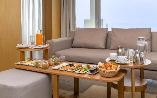 a living room with a table with food on it at Royal Azur Thalassa in Hammamet