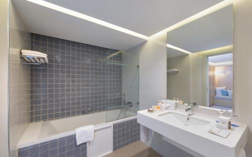 a bathroom with a sink and a mirror at Royal Azur Thalassa in Hammamet