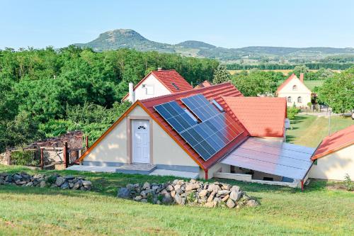 a house with solar panels on its roof at Bazaltorgona Apartman in Kisapáti