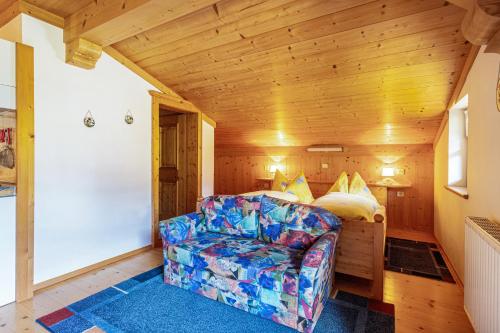 a living room with a couch and a bed at Ferienwohnung Weissbacher in Sankt Martin bei Lofer