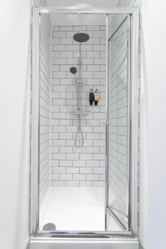 a shower with a glass door in a bathroom at The Madison - Premium Self Check-In Studios & Apartments in Southampton