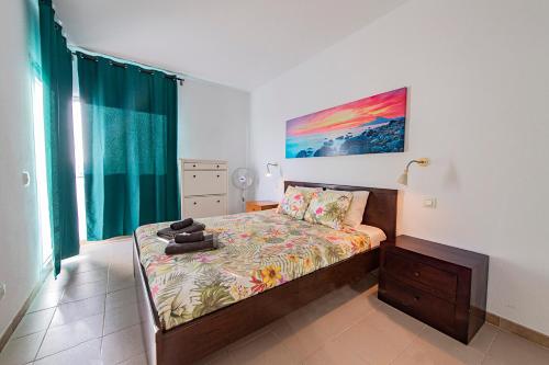1 dormitorio con 1 cama y una pintura en la pared en Paradise Suite, en Adeje