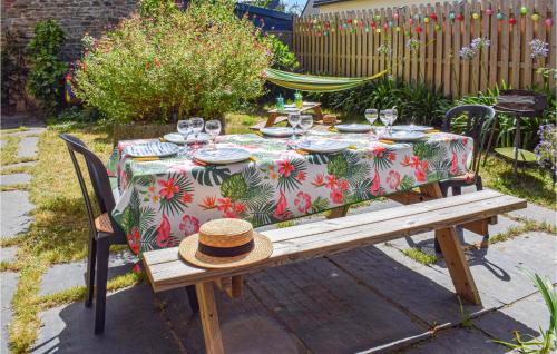 a table with a table cloth with glasses and a hat on it at 5 Bedroom Cozy Home In Lézardrieux in Lézardrieux