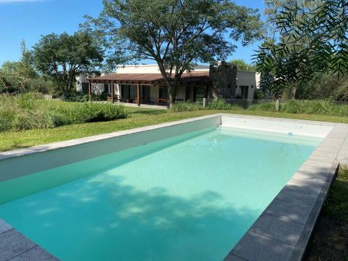 a swimming pool in front of a house at Acogedora y amplia casa en Salta! in Salta