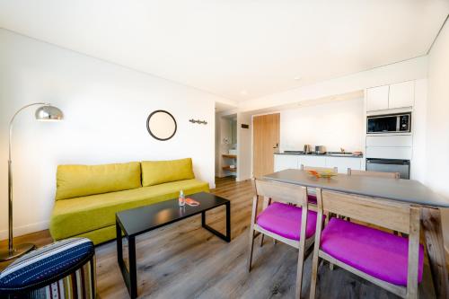 a living room with a yellow couch and a table at Cilene del Fuego Suites & Spa in Ushuaia