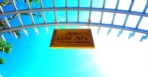 a sign hanging from the ceiling of a building at Hải An Homestay - Garden by the Beach in Phan Rang