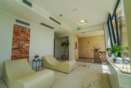 a lobby of a hospital with two white chairs at Grand Hotel San Pietro Taormina in Taormina