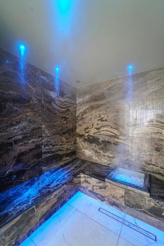 a large bathroom with a tub with blue lights at Grand Hotel San Pietro Taormina in Taormina